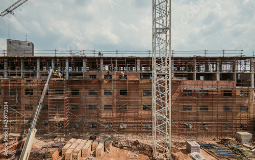 Construction site of multi-storey building with concrete slabs and columns. Men at work .