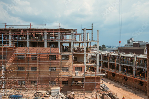 Construction site of multi-storey building with concrete slabs and columns. Men at work .