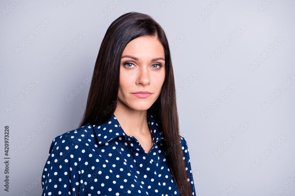 Photo of strict brunette girl wear blue blouse isolated on grey color background Photo of strict brunette girl wear blue blouse isolated on grey color background