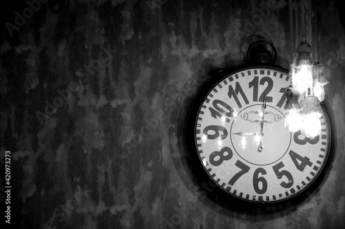 Wallpaper Mural old clock hanging on the wall behind yellow bulbs Torontodigital.ca