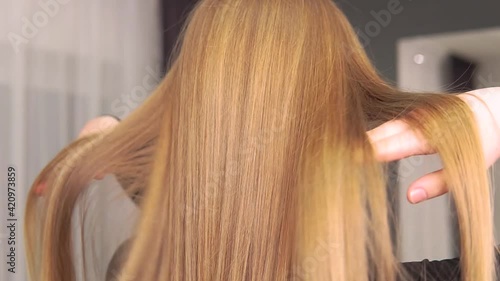 Back view of beautiful long healthy red hair. Professional hair care. Beauty salon.