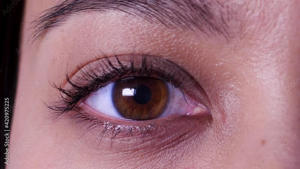 Extreme close up, opening asian female brown eye in slow motion, static Extreme close up, opening asian female brown eye in slow motion, static