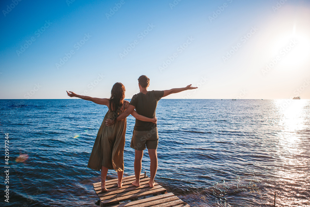 Fototapeta premium Young couple on white beach at summer vacation