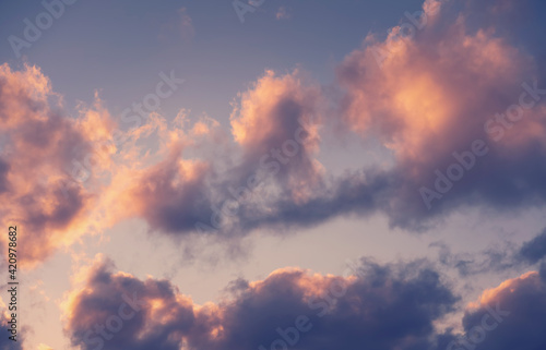 Beautiful dramatic sky with dark clouds at sunset, natural abstract background texture.