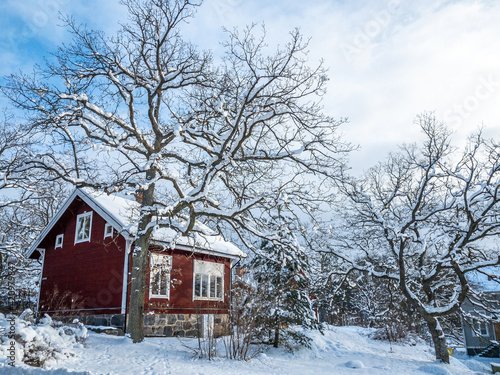 Renovated old tree house surrounded with snow in suburbs of Stockholm
