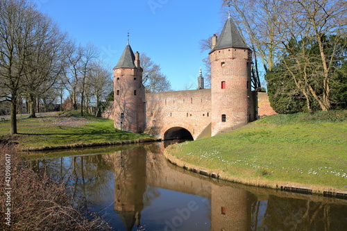 Reflections of the Monnikendam (water gate) in Amersfoort, Utrecht, Netherlands, with Onze Lieve Vrouwe Toren (Church Tower of our Lady) in the background