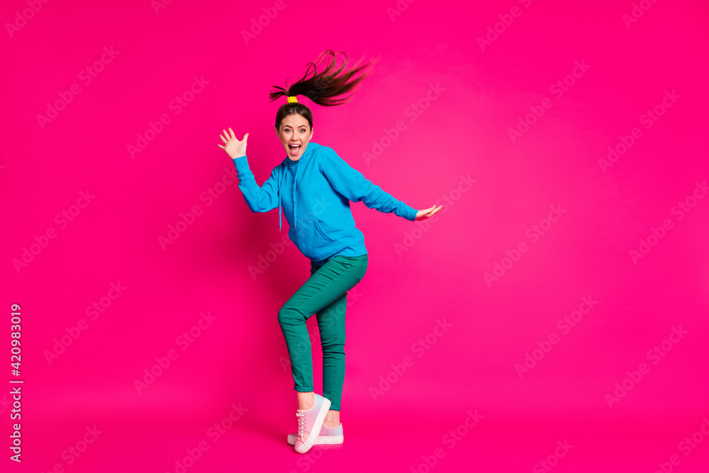 Full length photo of charming pretty young lady wear blue sweater dancing isolated bright pink color background