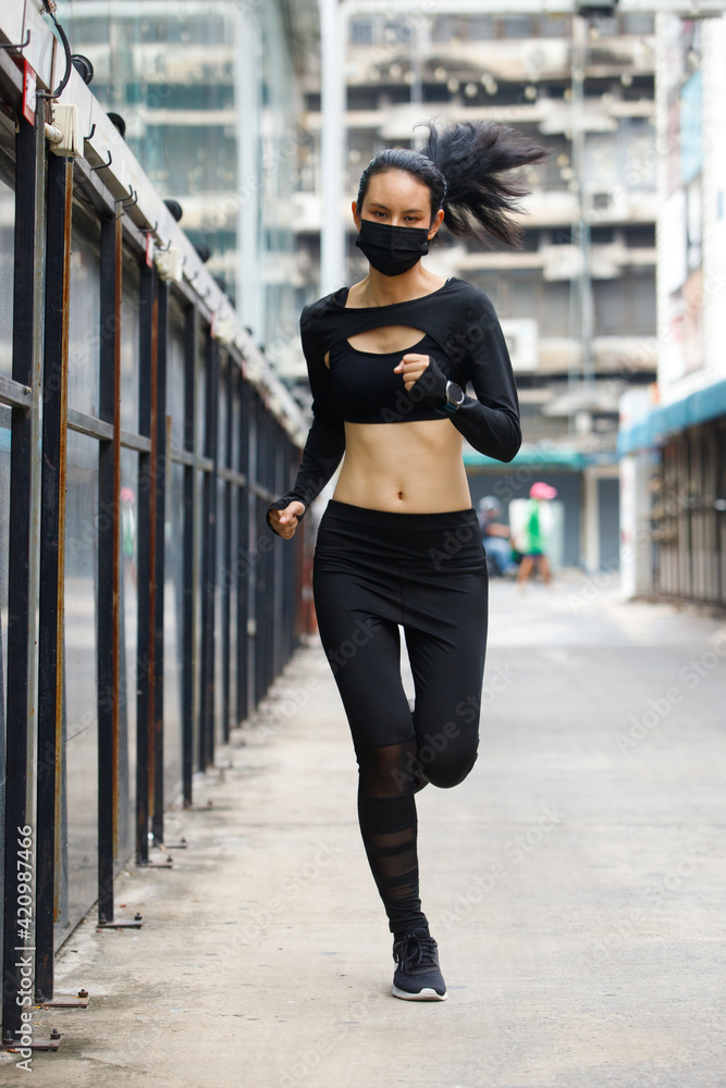 Asian slim Fitness woman jogging running Outdoor under street