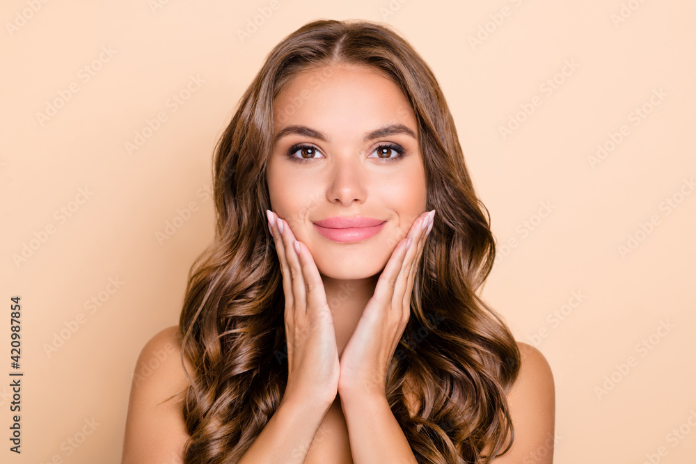 Photo of nice long hairdo optimistic lady without clothes hands face isolated on pastel beige color background Photo of nice long hairdo optimistic lady without clothes hands face isolated on pastel beige color background