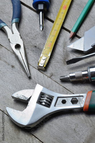 some home repair tools lie on a wooden background. close-up.