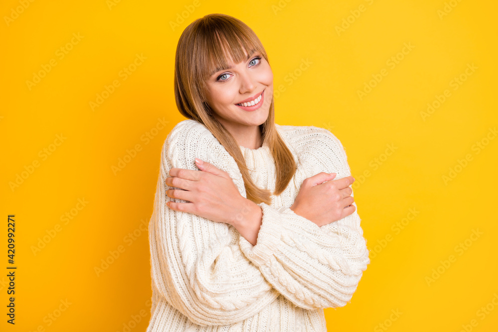 Photo of adorable person toothy smile hug shoulders wear warm knitted sweater isolated on yellow color background Photo of adorable person toothy smile hug shoulders wear warm knitted sweater isolated on yellow color background