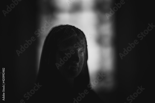 silhouette of a woman statue in the darkness