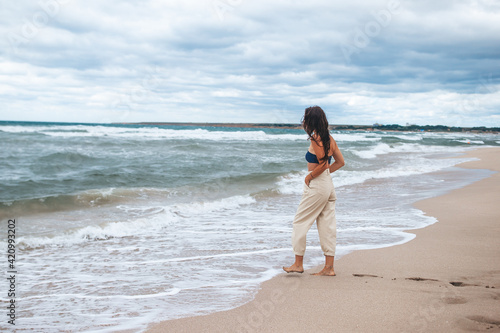 Young happy woman on the beach