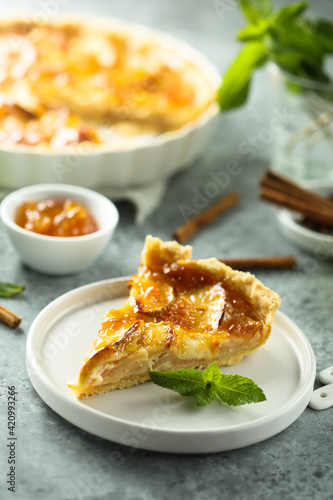 Traditional homemade apple tart with apricot jam
