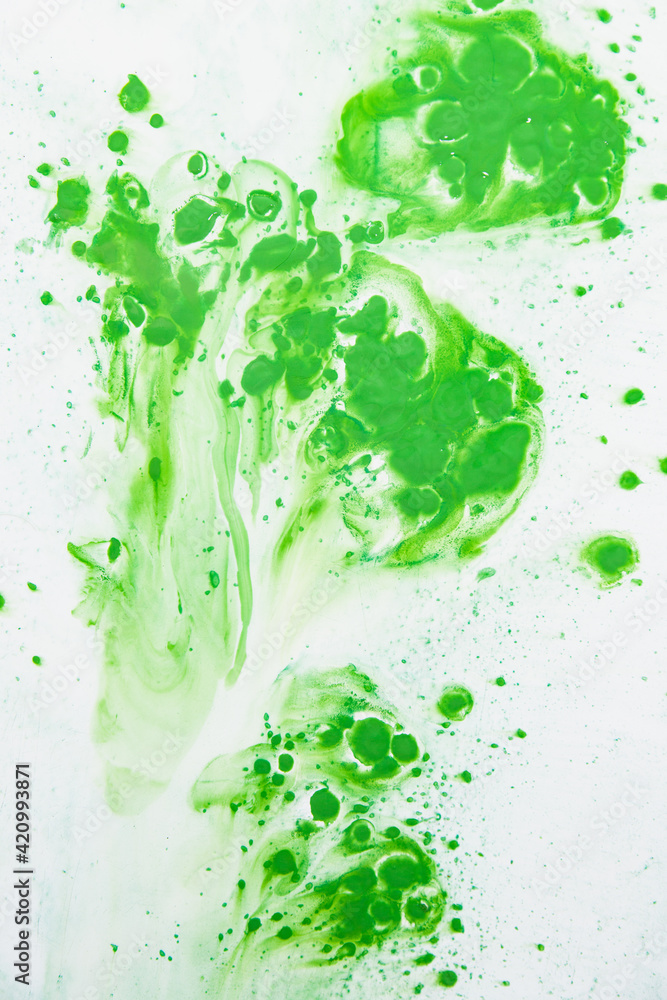 White wall with chaotic green paint drops White wall with chaotic green paint drops