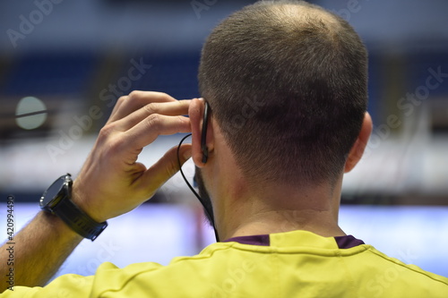 Detail with referee and earphone headset during a handball game