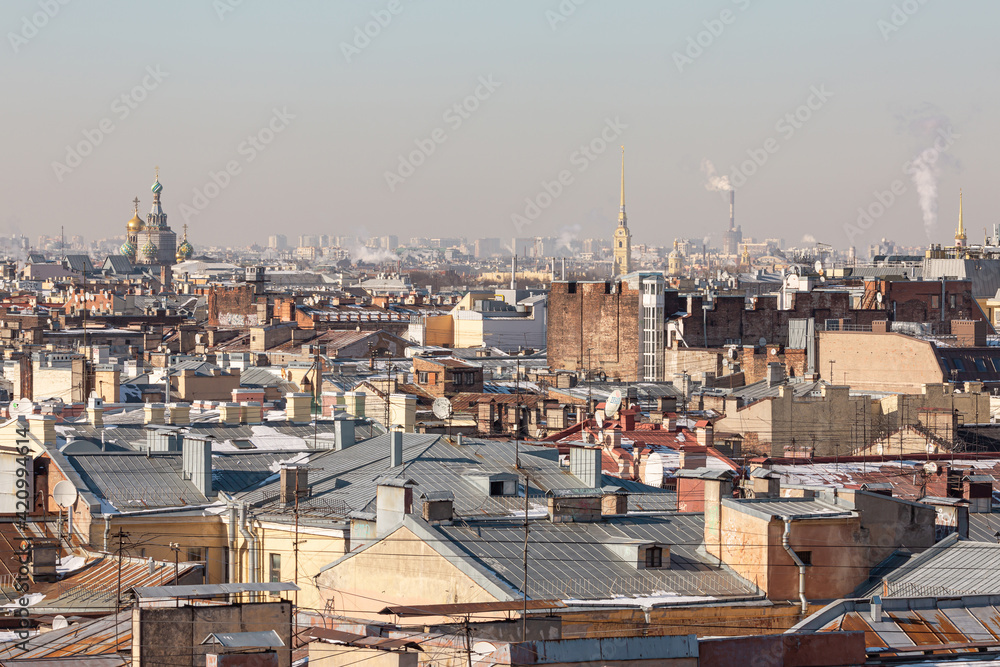 Sunny spring day in Saint Petersburg, Russia. View on the rooftops in the city center and a huge tower on the horizon.