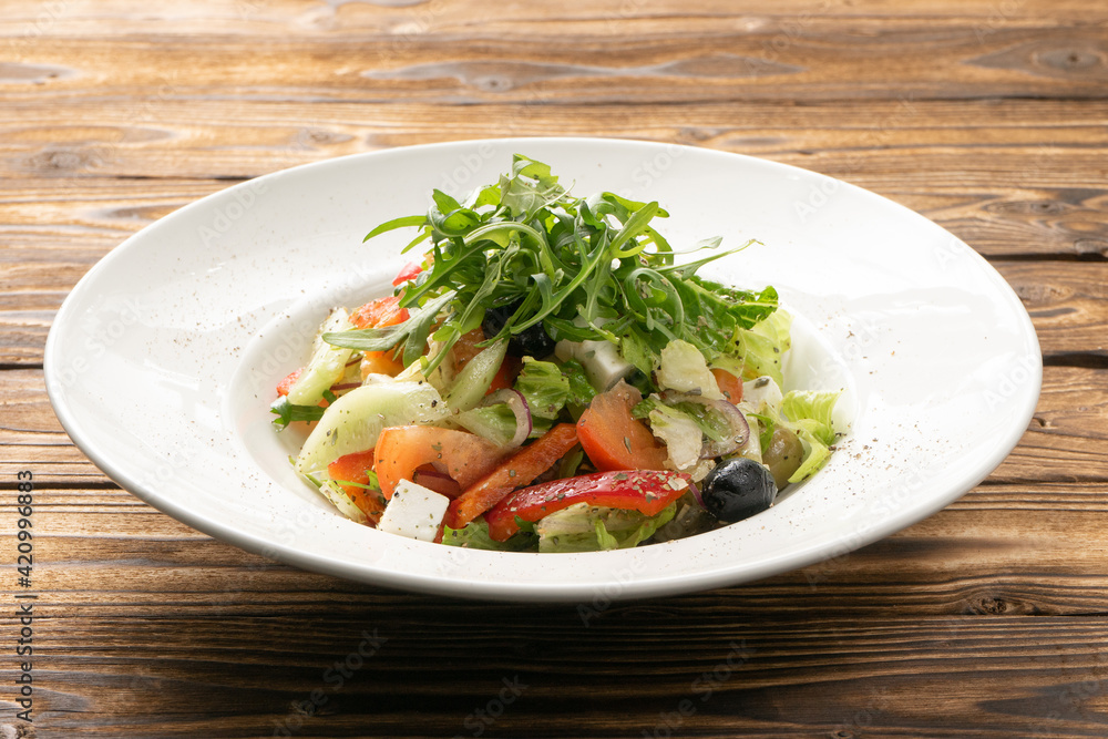 Vegetarian Greek salad with arugula, olives and feta cheese Vegetarian Greek salad with arugula, olives and feta cheese