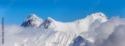Caucasus mountains, Kardyvach peak, sun, snow and blue sky © alzakh