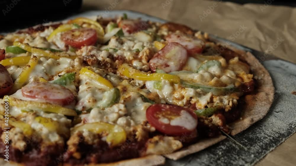 Close up of cutting roll cut through cheesy thin crust Pizza. Close up of cutting roll cut through cheesy thin crust Pizza.