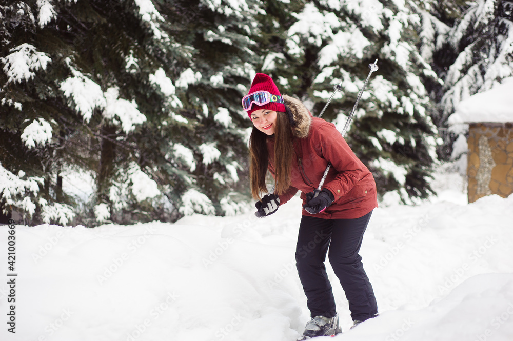 Woman skiing in the winter forest. Inexperienced skier skiing training. Young caucasian woman skier
