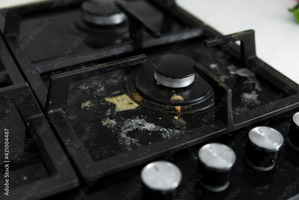 Dirty black glass kitchen stove in home kitchen. Dirty black glass kitchen stove in home kitchen.