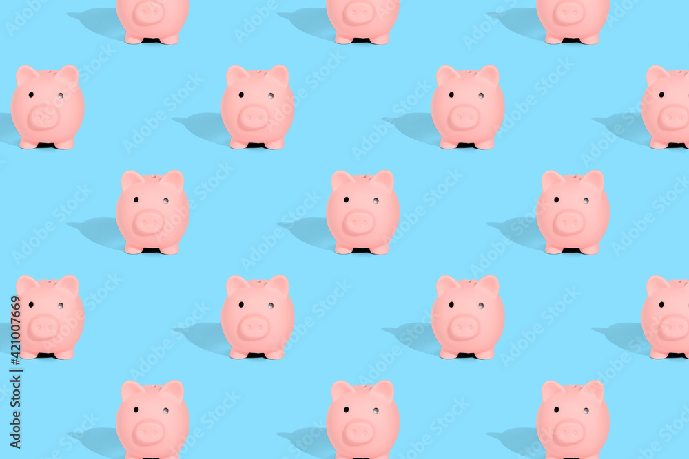 . Pattern of pink piggy banks on a blue background. Financial savings concept . Pattern of pink piggy banks on a blue background. Financial savings concept