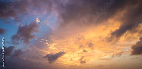 Sunset with sun rays, sky with clouds and sun.