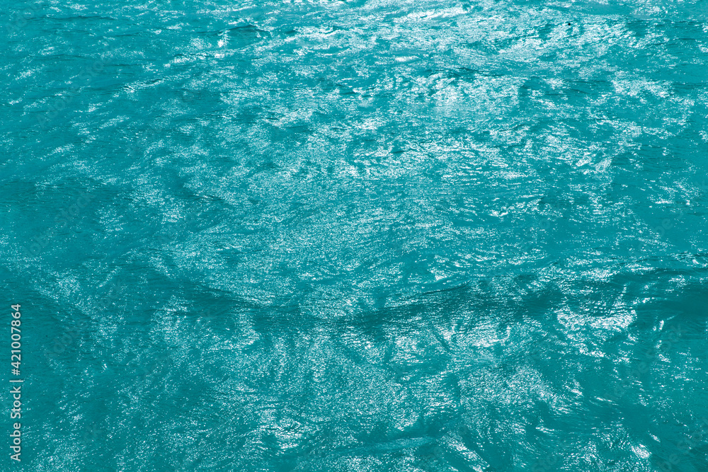 Blue water with sun reflections Blue water with sun reflections