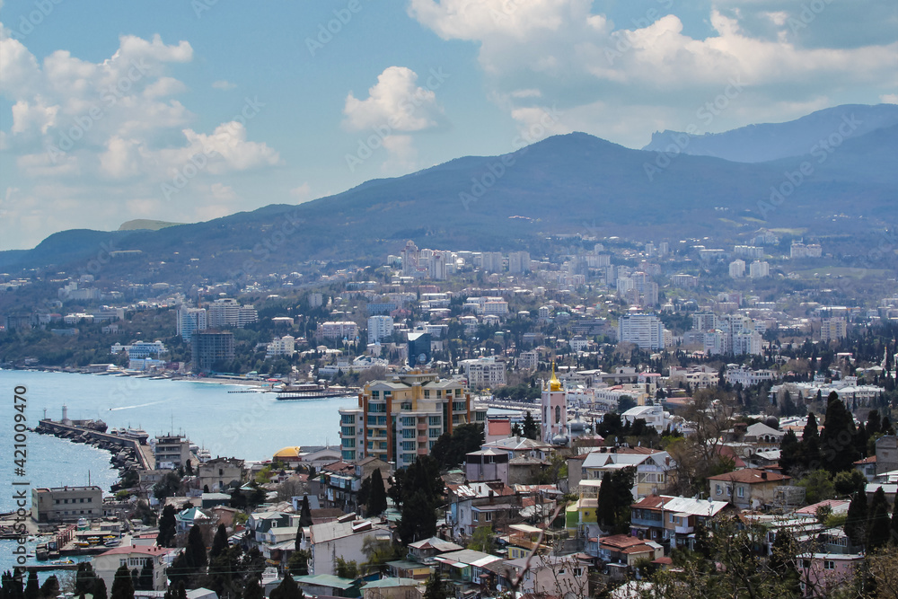 The city of Yalta and the panorama of the Crimean mountains, from the top of the hill.