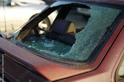 Broken rear window in car, thief smashed window and stole valuable items concept