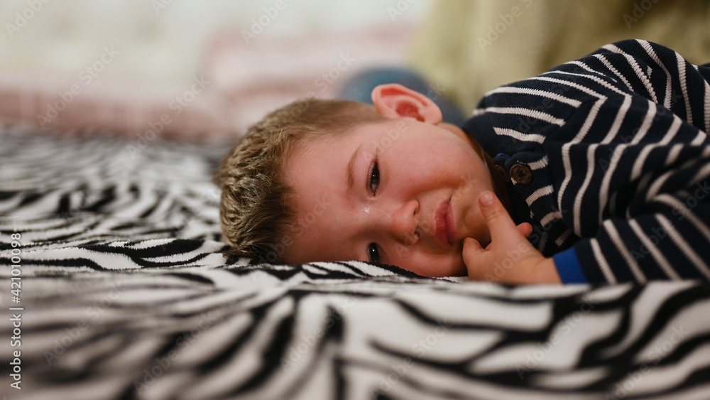 Baby crying lying on the bed, close up Stock Photo Adobe Stock