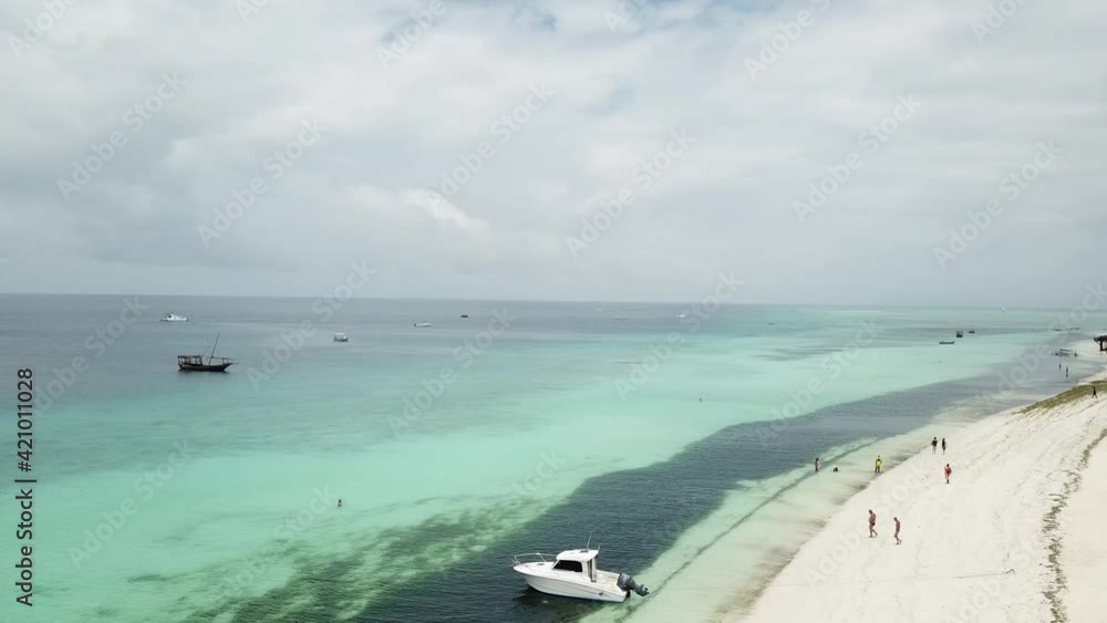 A sweeping shot of a white sand Zanzibar beach. A sweeping shot of a white sand Zanzibar beach.