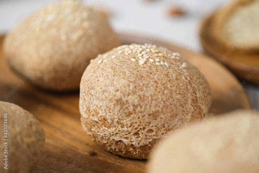 Gluten free Keto bread. Homemade ketogenic buns with sesame seeds. set on white cafe table. Gluten free Keto bread. Homemade ketogenic buns with sesame seeds. set on white cafe table.