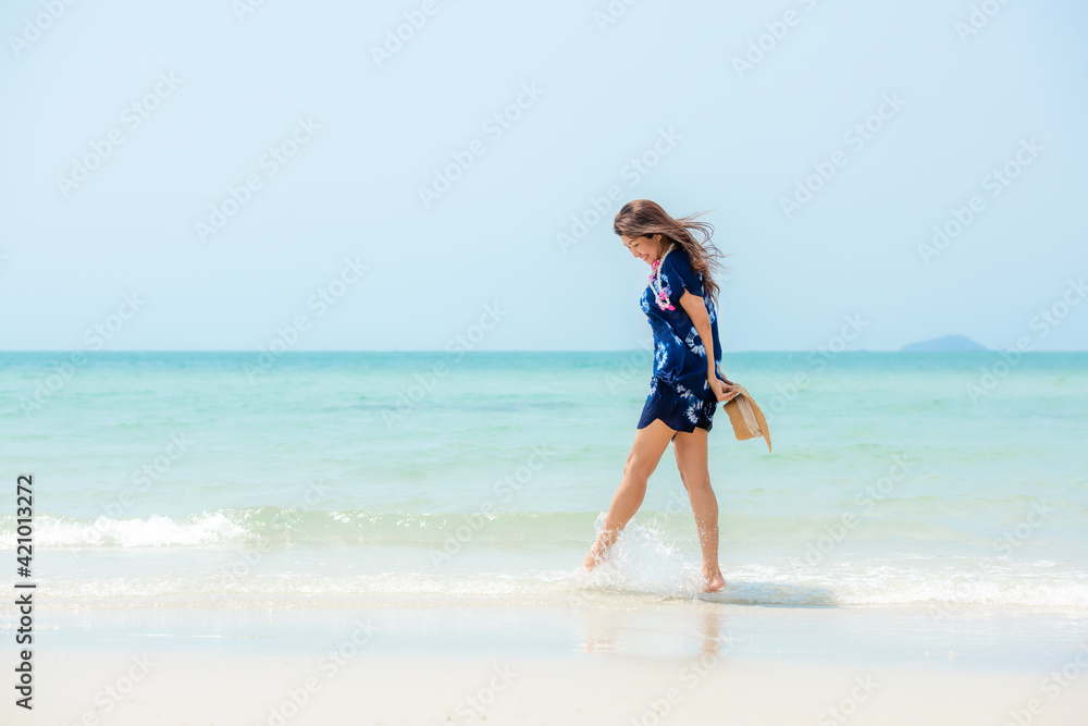 Summer vacations. Lifestyle woman relax and chill on beach background.  Asia happy young people walking on the wave sea, summer trips enjoy  