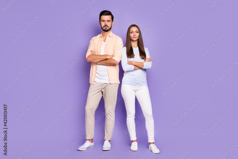 Fototapeta premium Full length photo of serious man and woman stand together confident folded hands isolated on purple color background