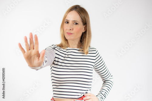 Wallpaper Mural Young caucasian woman over isolated white background making stop gesture Torontodigital.ca