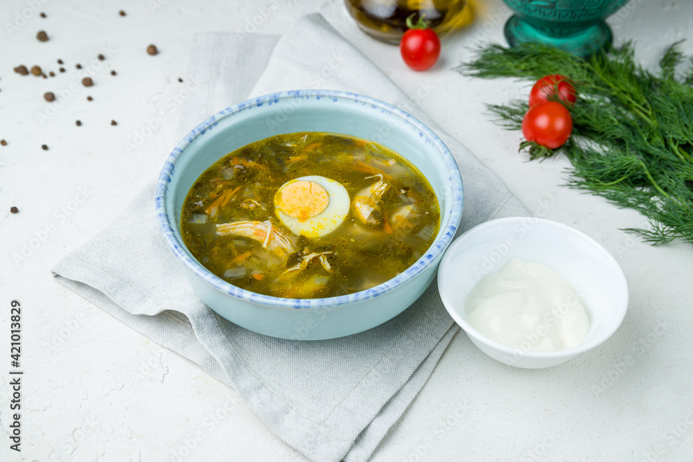 Sorrel soup with egg on white concrete table Sorrel soup with egg on white concrete table