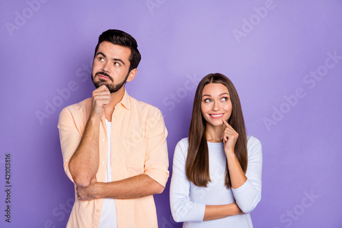 Photo of two positive persons arm finger on chin look interested empty space isolated on violet color background