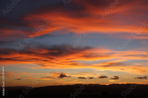 Pink and orange clouds in the evening sky, natural background © Oksana
