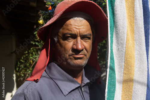 Portrait of a Brazilian farmer wearing clothes to protect himself from the sun