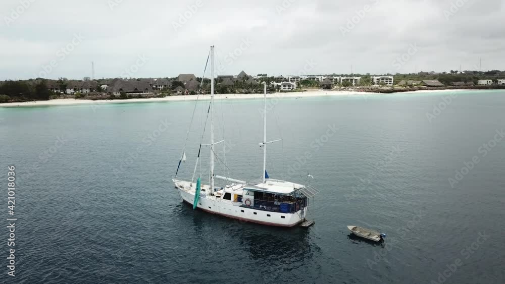 Sailboat floating close to the white sanded shore. Sailboat floating close to the white sanded shore.