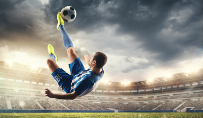 Male football or soccer player at stadium in flashlight. Young male sportive model training. Moment of attacking, catching. Concept of sport, competition, winning, action, motion, overcoming. Flyer.