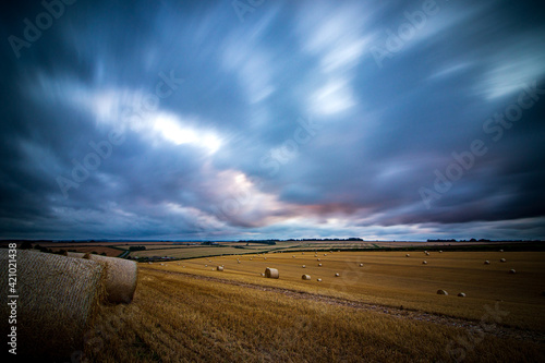 Storm over Field of Hay Bales