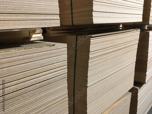 Warehouse for wooden materials. Particleboard and fiberboard close-up. Preparation of elements for creating products
