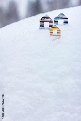 Conceptual paper houses in snow forest