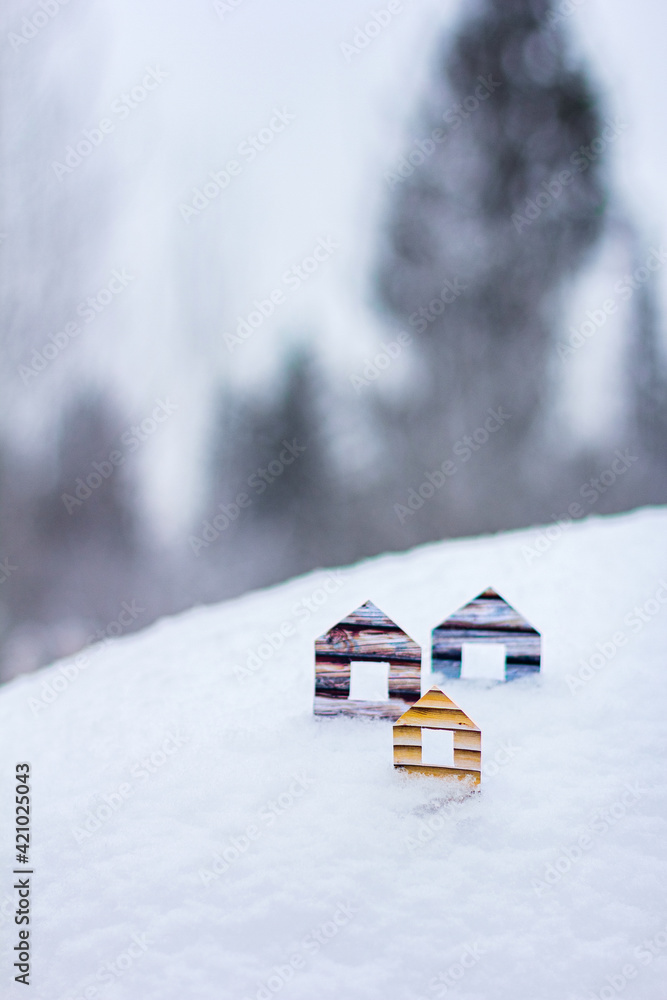 Conceptual paper houses in snow forest