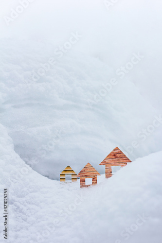 Conceptual paper houses in snow forest © Anatoly