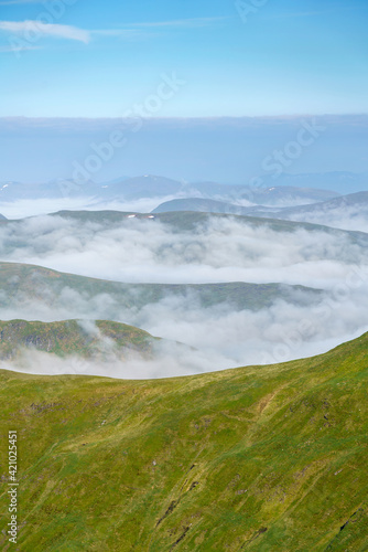 Cloud inversion in the glens, valleys, behind the mountain ridge of Sron Dha Mhurchaidh from summit of Beinn Ghlas in the Scottish Highlands, UK landscapes. photo