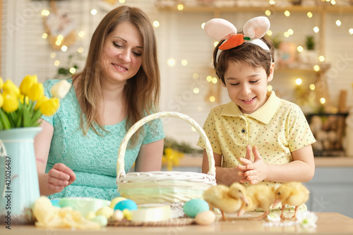 Mother and son having fun together and celebrating feast. family getting ready for easter. Little and mom decorating home. soft focus